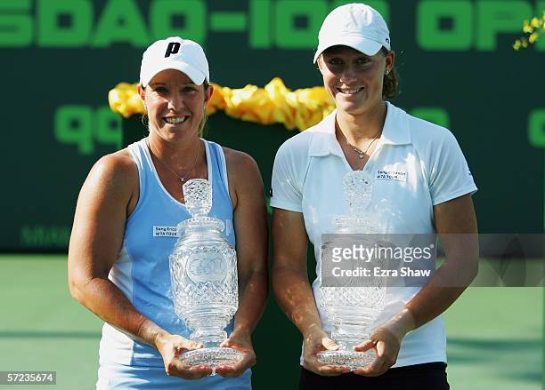 Lisa Raymond and Samantha Stosur of Australia pose with their trophies after winning the women's doubles final by defeating Martina Navratilova and...