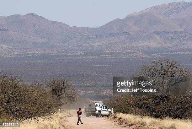 Minutemen volunteer walks back to his checkpoint after talking with a U.S. Border Patrol agent on a ranch in the Sonoran Desert in Altar Valley April...
