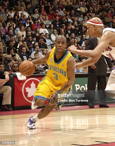 Chris Paul of the New Orleans/Oklahoma City Hornets drives in against Charlie Villanueva of the Toronto Raptors on April 2, 2006 at the Air Canada...