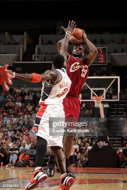 LeBron James of the Cleveland Cavaliers shoots over Gerald Wallace of the Charlotte Bobcats on April 2, 2006 at the Charlotte Bobcats Arena in...