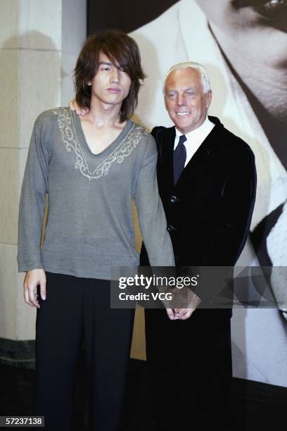 Italian fashion designer Giorgio Armani poses with Taiwan entertainer Jerry Yan during a fashion show on April 1 at the Shanghai Grand Theatre in...