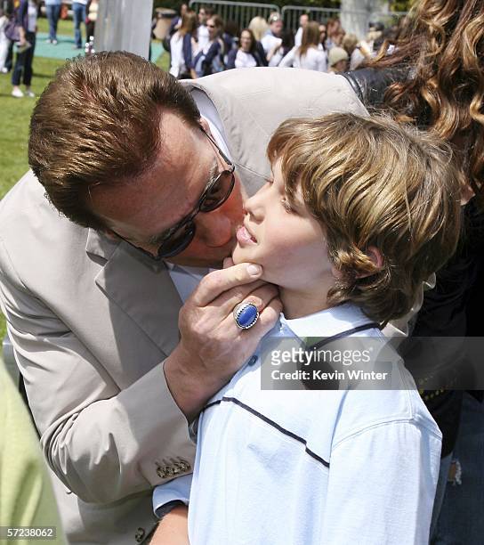 Gov. Arnold Schwarzenegger and kisses his son Christopher at a pre-premiere softball game with "The Benchwarmers" at UCLA's Sunset Canyon Recreation...