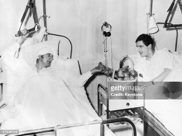 Manchester United footballers Dennis Viollet and Albert Scanton share a basket of fruit in their ward at Isar Hospital Munich, after the air crash...