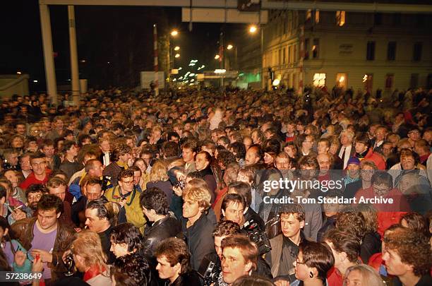 Crowds gather at Check Point Charlie on the night of November 9th when East Berliners were allowed to cross into the west for the first time. Hours...