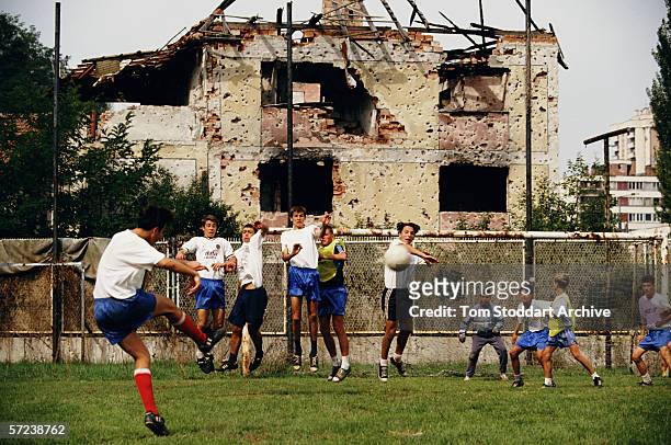 Footballers from FK Zeljeznicar Club in Sarajevo train for a match as the city begins to come to life again after four years of siege and conflict.