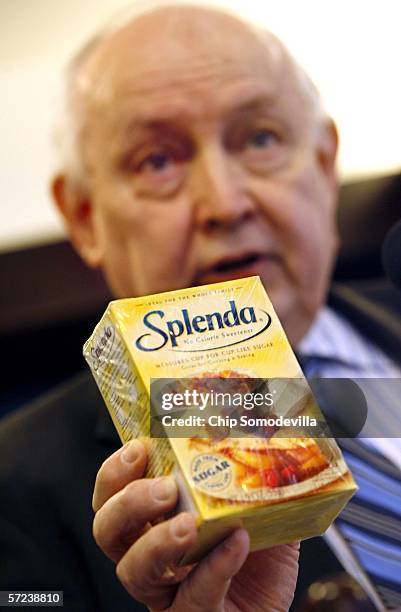 Chairman of the board of Citizens for Health, Jim Turner, holds a box of the artificial sweetener Splenda during a press conference at the National...