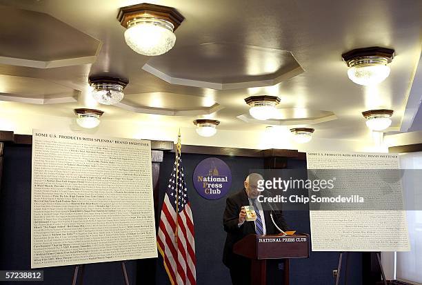 Flanked by posters lising the names of consumer products that use sucralose, or Splenda, Chairman of the board of Citizens for Health, Jim Turner,...
