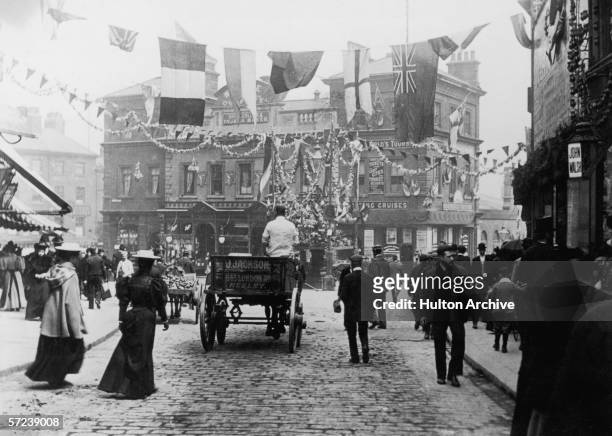 Flags and bunting decorate the marketplace in Sheffield, circa 1905.