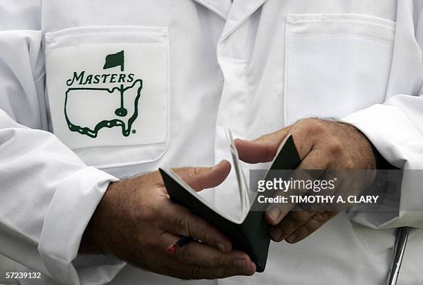 Augusta, UNITED STATES: A caddie looks over his yardage book before the start of his first practice round 03 April, 2006 at the Augusta National Golf...