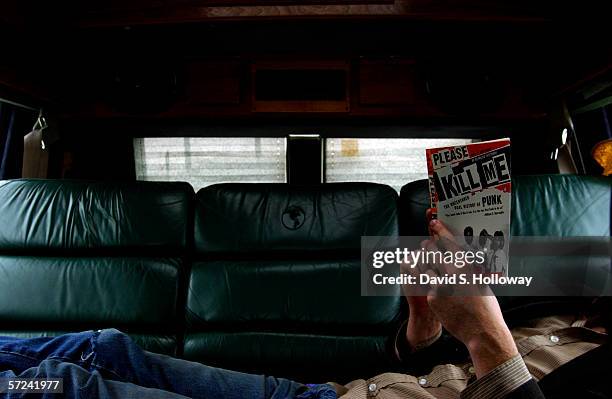 Jonathon Ford of the band Decahedron stretches across the backseat of the band's van while reading the book the Oral History of Punk on February 10,...