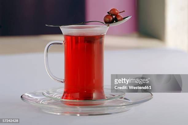 rose hip tea in glass - ローズヒップティー ストックフォトと画像