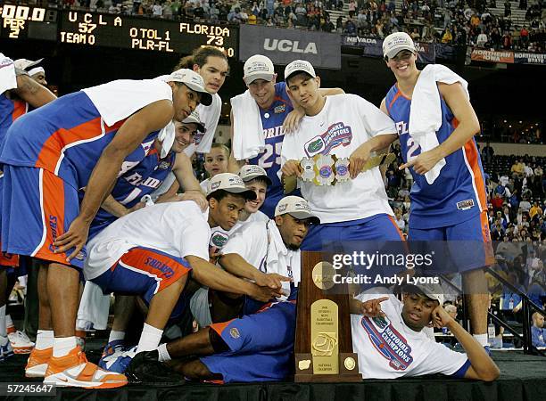 The Florida Gators celebrate with the trophy after defeating the UCLA Bruins 73-57 during the National Championship game of the NCAA Men's Final Four...