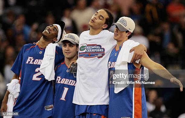 Corey Brewer, Brett Swanson, Joakim Noah and Jack Berry of the Florida Gators celebrate after defeating the UCLA Bruins 73-57 during the National...