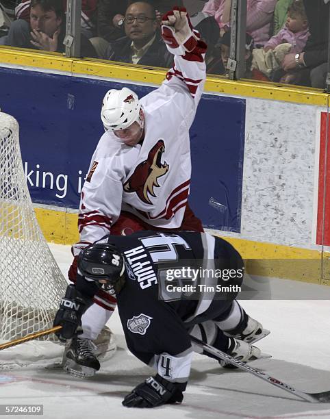 Ryan Smyth of the Edmonton Oilers gets tangled up with Keith Ballard of the Phoenix Coyotes in the Coyotes zone during the first period of NHL action...