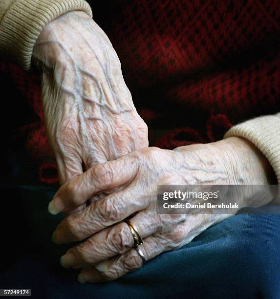 Year old Pensioners clasps her hands together during a group exercise in a day care centre on April 4, 2006 in London England. The State Pension...