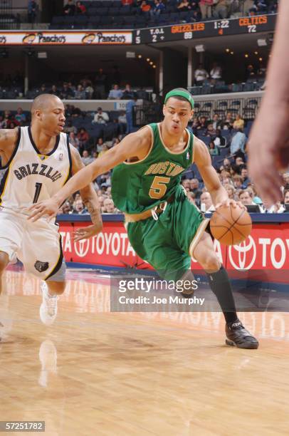 Gerald Green of the Boston Celtics dribbles against Antonio Burks of the Memphis Grizzlies on March 14, 2006 at the FedExForum in Memphis, Tennessee....