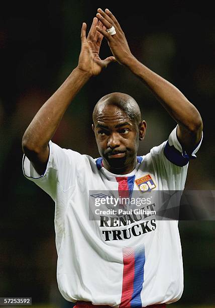 Captain Claudio Cacapa of Lyon applauds the crowd following defeat during the UEFA Champions League Quarter Final Second Leg match between AC Milan...