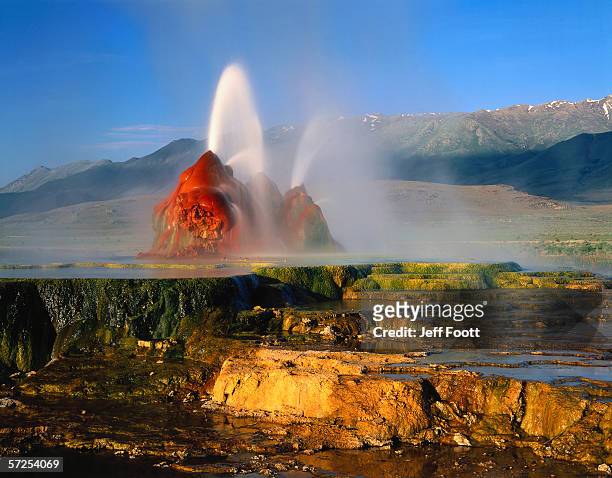 geysers spew water near snowcapped mountains. black rock desert-high rock canyon emigrant trails national conservation area, nevada. - great basin photos et images de collection