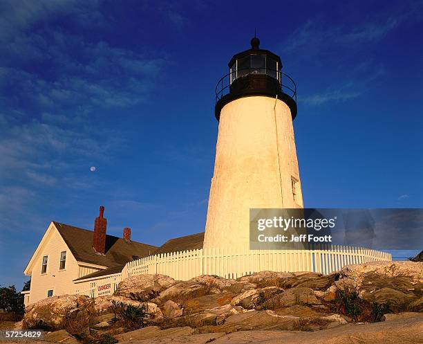 moon still present as sunrise falls upon a lighthouse. maine. - generic safety sign stock pictures, royalty-free photos & images