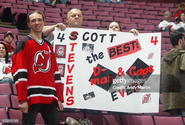 Fans hold up a sign for retiring defenseman Scott Stevens of the New Jersey Devils before the game against the Carolina Hurricanes on February 3,...