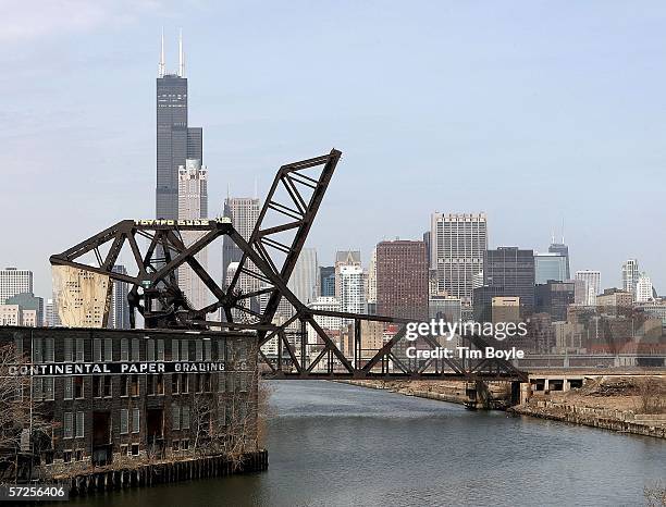 With a south view of Chicago's skyline, including the Sears Tower, one CSX railroad Strauss heel-type trunnion bascule bridge over the South Branch...