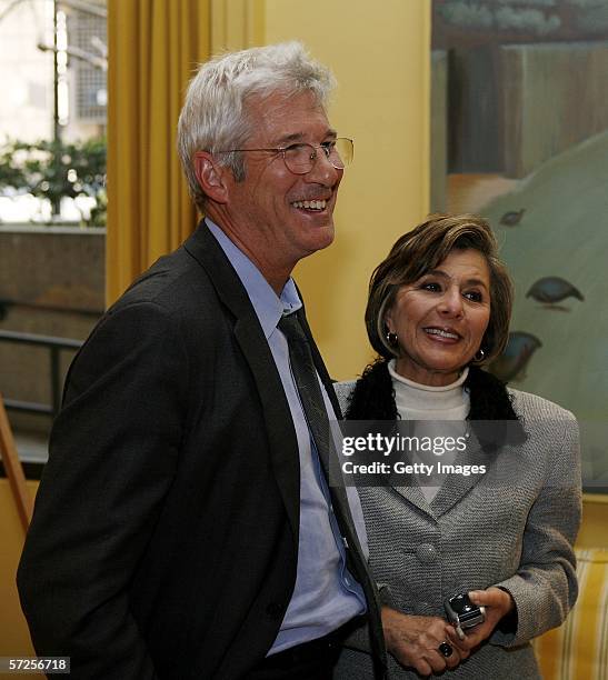 Actor Richard Gere speaks with Senator Barbara Boxer during a reception held at the MPAA by Friends of the Global Fight April 4 in Washington, DC.