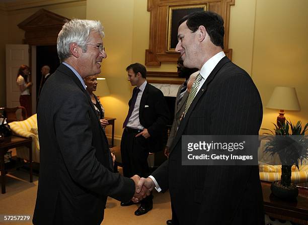 Actor Richard Gere shakes hands with Senator Rick Santorum during a reception held at the MPAA by Friends of the Global Fight April 4 in Washington,...