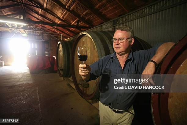 General manager of family-owned business Tyrrells Wines, Bruce Tyrrell examines a glass of pinot noir in the number one vat room at the company's...