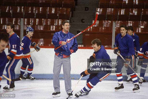 New York Islanders head coach Al Arbour gestures with a hockey stick during team practice for an upcoming game against the Montreal Canadiens at the...