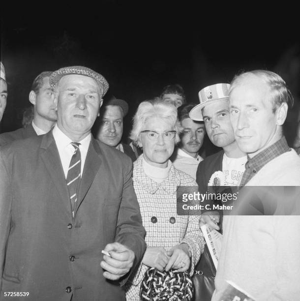 Footballer Bobby Charlton meets his parents Bob and Cissie Charlton outside the dressing room at Wembley Stadium during the 1966 World Cup in...