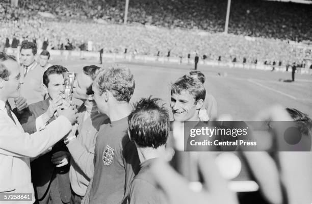 England celebrate on the pitch after England's victory in the 1966 World Cup final at Wembley, 30th July 1966. Captain Bobby Moore, and Roger Hunt...