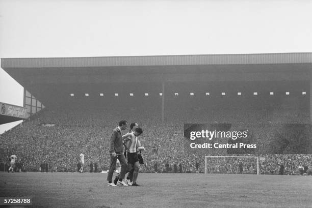 Argentinian footballer Jorge Albrecht is lead from the pitch at Villa Park after being sent off in the Group B match against West Germany during the...
