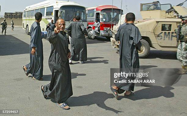 Freed Iraqi prisoner flashes the "V" sign after he was released from Abu Ghraib prison in Baghdad, 25 March 2006. Some 4,500 are held in the US-...