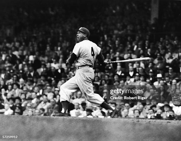 American baseball player Duke Snider follows the ball with his eyes after getting a hit during a game, 1956.