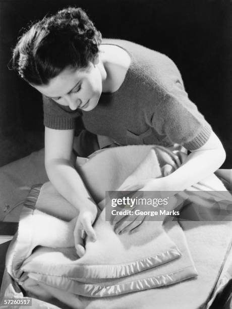 woman inspecting woollen blanket, (b&w) - hot housewives stock pictures, royalty-free photos & images