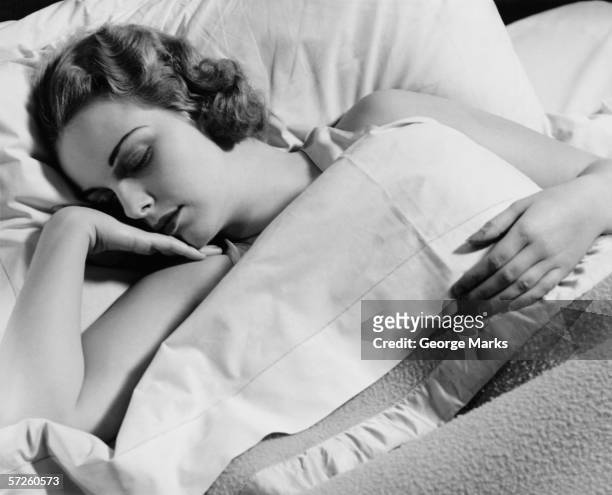 young woman asleep in bed, (b&w), close-up - 1940s bedroom stock pictures, royalty-free photos & images