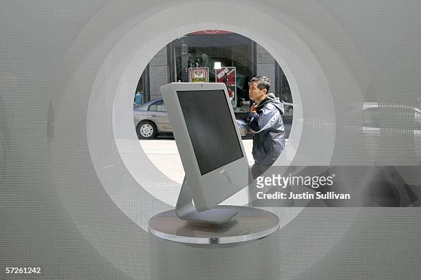 Man looks at a window display featuring an Apple iMac computer at an Apple Store April 5, 2006 in San Francisco. Apple Computer Inc. Unveiled "Boot...