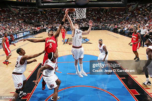 Kyle Korver of the Philadelphia 76ers rebounds against Josh Smith of the Atlanta Hawks on March 22, 2006 at the Wachovia Center in Philadelphia,...