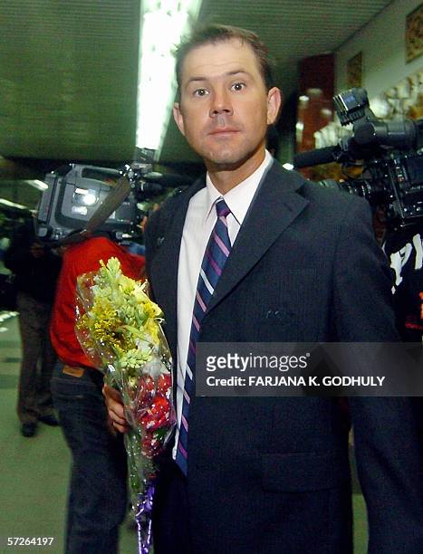 Australian cricket captain Ricky Ponting holds a floral bouquet after arriving at Zia International airport in Dhaka, 06 April 2006. Australia are...