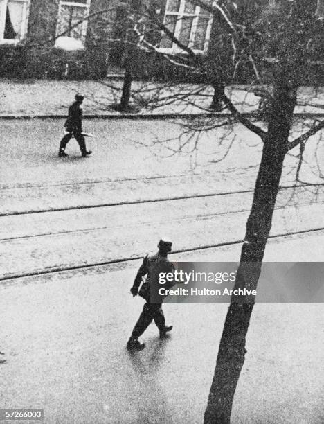 Gestapo officers patrolling the streets in Holland during World War II, circa 1945.