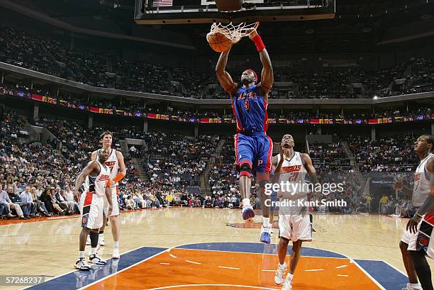 Ben Wallace of the Detroit Pistons dunks against Bernard Robinson of the Charlotte Bobcats on March 18, 2006 at the Charlotte Bobcats Arena in...