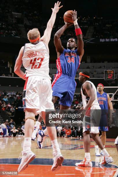 Antonio McDyess of the Detroit Pistons shoots against Jake Voskuhl of the Charlotte Bobcats on March 18, 2006 at the Charlotte Bobcats Arena in...