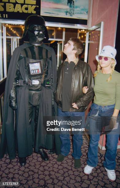 Noel Gallagher of rock group Oasis with his wife Meg Matthews with an actor in costume as Darth Vader at the premiere of the 'Star Wars' Special...