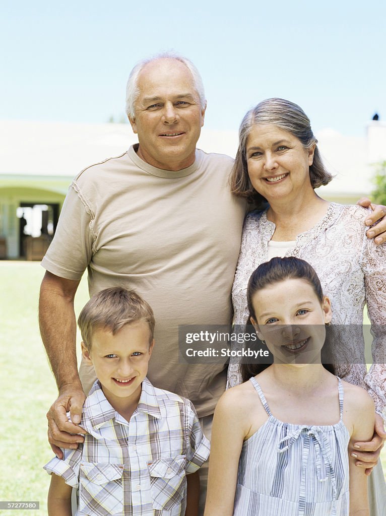 Portrait of grandparents with their grandchildren in a garden
