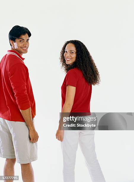 rear view of a young couple looking over shoulder - boss over shoulder stock pictures, royalty-free photos & images