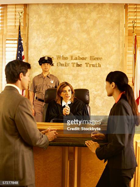 rear view of two lawyers approaching the judge - lawyers arguing stock pictures, royalty-free photos & images