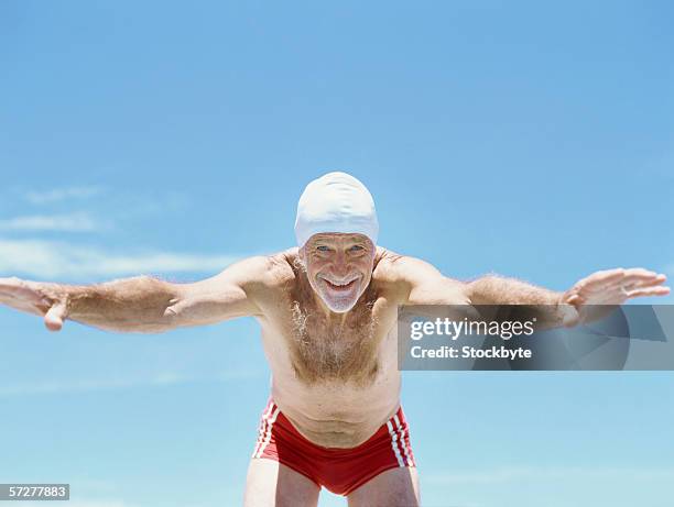 senior man diving into swimming pool - old people diving stock pictures, royalty-free photos & images