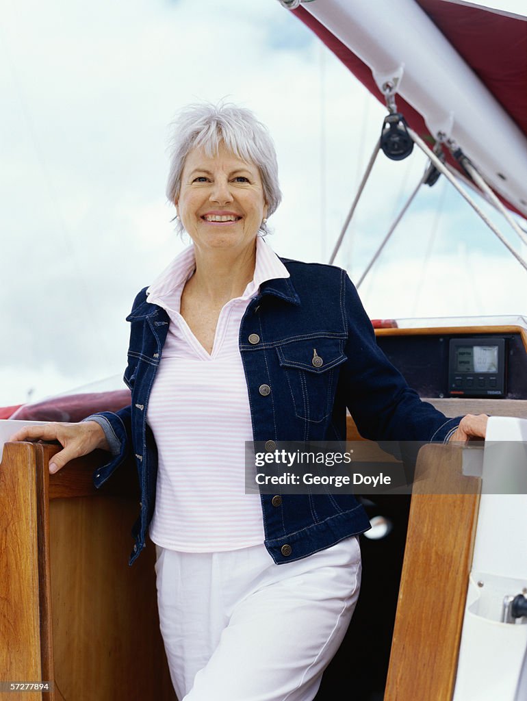 Senior woman standing on a sailboat
