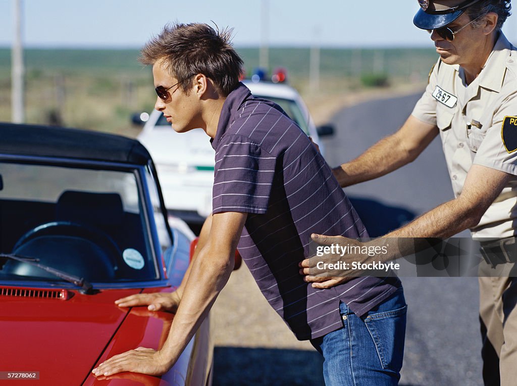 Side profile of a policeman checking a young man