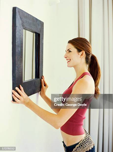 side profile of a young woman looking into a mirror - draped stock pictures, royalty-free photos & images